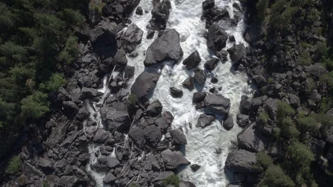 Aerial approach to a rocky waterfall View of the valley with a powerful river Stock Footage 123714531