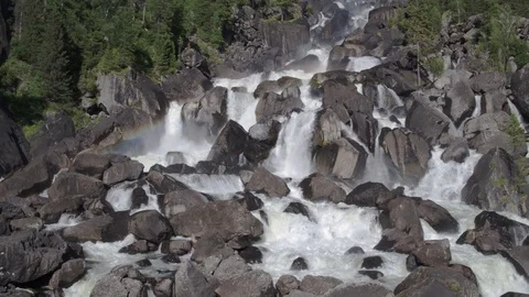 Aerial approach to a rocky waterfall View of the valley with a powerful river Stock Footage 123714839
