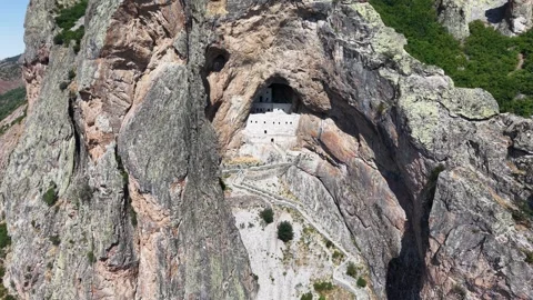 Aerial Approach Toward Ancient Cliffside Stone Structure in Mountain Landscape Video stock 339449581