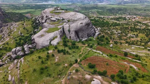 Aerial Approach Toward Massive Rounded Gray Rock Formation Stock Footage 344437022