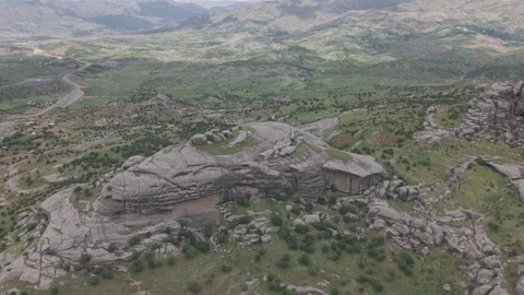 Aerial Approach Toward Massive Smooth Rounded Gray Rock Stock Footage 344648602