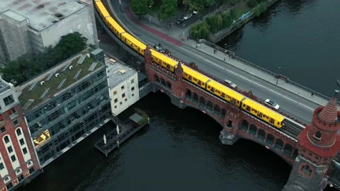 Aerial approach toward Oberbaum bridge with rapid transit train crossing, Berlin Stockbeeldmateriaal 237524650