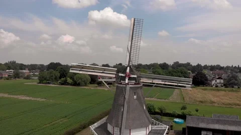 Aerial approach of typical Dutch windmill with wooden structure wicks in Stock Footage 157464349
