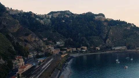 Aerial approaching panning view of the bay of Taormina in Sicily Stock Footage 114215468