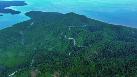 Aerial approaching shot of Zigzag Road with Turtle Bay in the background in Stock Footage 296640566