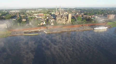 Aerial approaching town with big church and low clouds,Cuijk,Netherlands Stock Footage