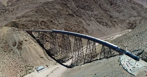 Aerial approaching train while it drives through old metal bridge. Salta 스톡 동영상 107224668