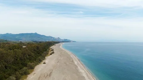 Aerial approaching view of a beach on the East coast of Sicily Stock Footage 106399475