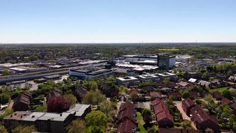Aerial approaching view of Brillux paint industrial factory area in German Stock Footage 334315770