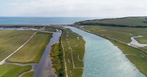 Aerial approaching view of the mouth of a river and the sea in Southern England Stock Footage 78611219