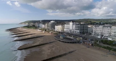 Aerial approaching view of the seafront and the beach of Eastbourne Stock-Footage 80986853