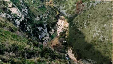Aerial approaching view of a small river in canyon in Cavagrande (Sicily) Stock Footage 105682270