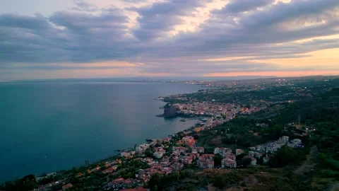 Aerial approaching view of the towns of Acicastello and Catania in Sicily Stock Footage 312799802