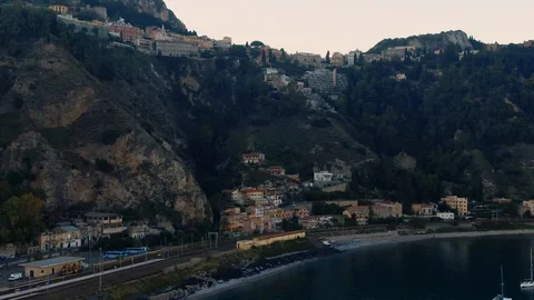 Aerial approaching view of the towns of Giardini Naxos and Taormina in Sicily Stock Footage 112006178