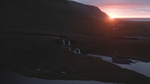 Aerial approaching view of a waterfall at sunset in West Iceland Stock Footage 115711637