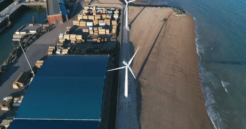 Aerial approaching view of wind turbines on the beach near Brighton in England Stock Footage 79095608