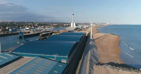Aerial approaching view of wind turbines on the beach near Brighton in England Stock Footage 80611631