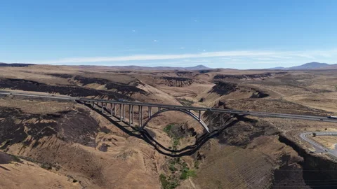 Aerial of arched bridge on Interstate 82 over deep canyon in Yakima Washington Stock Footage 338311210