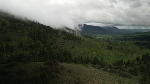 Aerial around low clouds in Cache National Forest in spring near Logan Utah Stock Footage 276849649