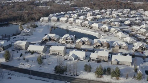Aerial around a subdivision of homes covered in snow Stock Footage 111663270