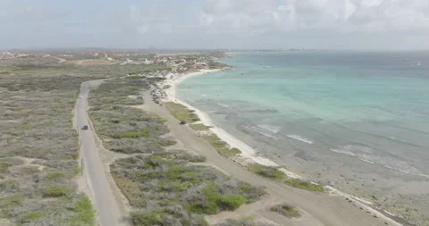 Aerial Aruba Car driving parallel to Arashi beach and Caribbean sea Stock-Footage 186322385