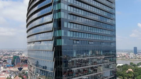 Aerial ascend at corner of mirror skyscraper in Southeast Asia - cityscape Stock Footage 99728340