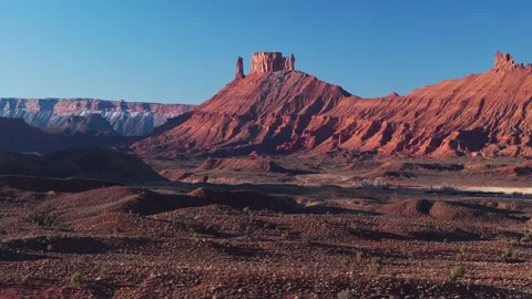 Aerial ascend of Moab deep red canyon, winding roads cutting through rugged Stock Footage 303626802