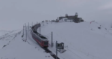 Aerial Ascending Forward Shot Of Train Moving Towards Observatory With Snow - Stock Footage 309329833