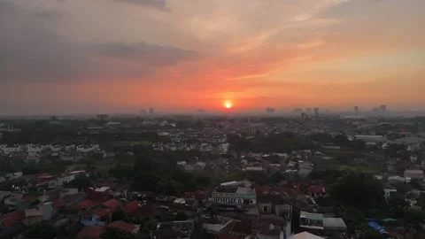 Aerial Ascending Shot of Dramatic Sunset Over Depok Suburb, Indonesia Stock Footage 338318919