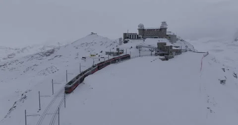 Aerial Ascending Shot Of Train Moving Towards Observatory With Snow - Zermatt, Stock Footage 309329767
