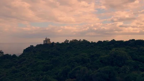 Aerial ascending view of a lighthouse at sunset in the East coast of Sicily Stock Footage 110801719