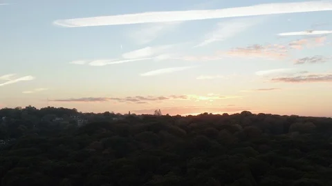 Aerial ascending view of  a sunset over a forest in North London Stock Footage 106392952