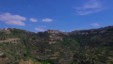 Aerial ascending view of the town of Centuripe in Sicily revealing Mount Etna Stock Footage 303569314