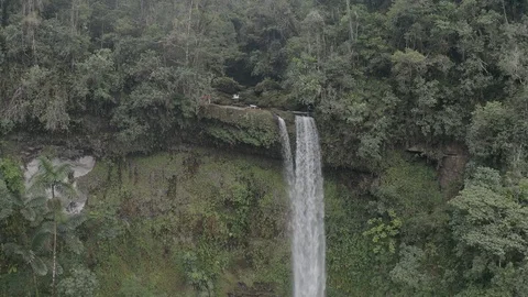 Aerial ascends and tilts down to reveal length of the Fin del Mundo waterfall Vídeos de archivo 104844801