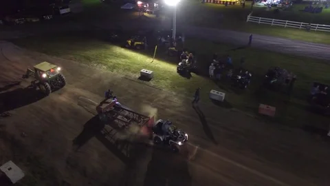 Aerial atv pull event at night quad pulling sled 4k Stock Footage 71205178