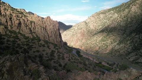 Aerial back away from cliffs above highway 50 near Cañon City Colorado Stock Footage 286242496