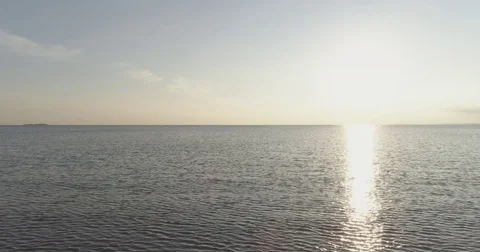 Aerial back fly over baltic sea in bright sunset time Stock Footage
