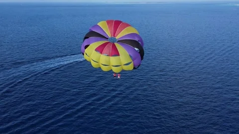 Aerial Back View of Double Parasailing Wing Over the Ocean Tugged by a Stock Footage 285135186