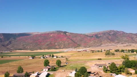 Aerial-Backing from mountain covered with fall leaves-rural community Stock Footage 140707368