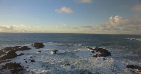 Aerial backing shot over waves in northern California ocean Stock Footage 81883741