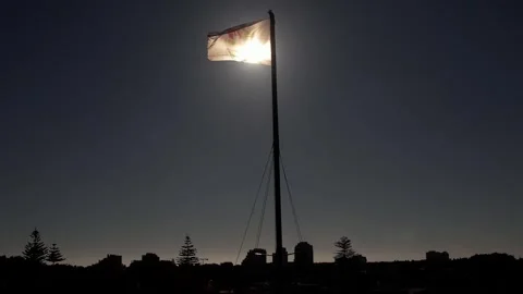 Aerial backlit view of flag at Cascais Bay ahead of Pope Francis's visit to Stock Footage 247022198