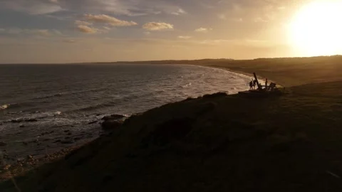 Aerial backlit view of friends standing on Cerro Chato in Santa Teresa Park Stock Footage 330976992
