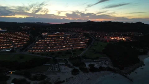 Aerial Backward Drone Flight Over Sardinian Coastline Hotel at Sunset Vídeo Stock 334564445