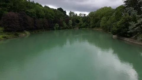 Aerial backward drone flying at low altitude over canal sea waters of Stock Footage 255014996