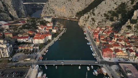 Aerial backward drone view of Omis, Croatia, river, town, and mountains. 動画素材 285270866