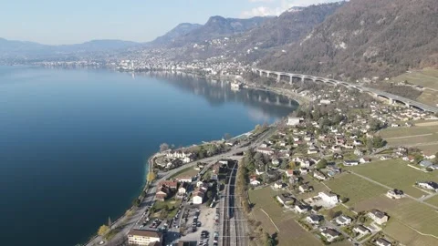 Aerial Backward Motion of Train Arriving in Villeneuve Station 4K 動画素材 330044048