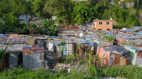 Aerial backward over dilapidated shacks near Ozama river, Santo Domingo Stock Footage 152603492