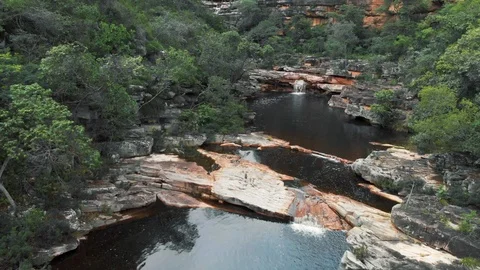 Aerial Backward-Ponds and Small Waterfalls Among Scenic Cliffs and Green Trees Stock Footage 107154341