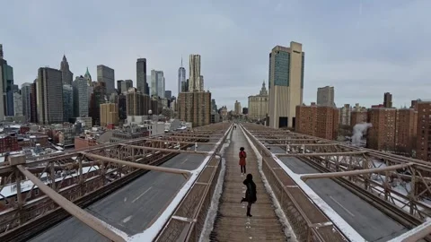 Aerial backward walking view on Brooklyn Bridge toward Manhattan skyline, USA Stock Footage 304318654
