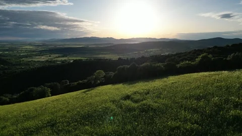 Aerial Backwards Flight Over Green Hills in Tuscany, Grosseto, Italy Revealing a Stock Footage 335818281
